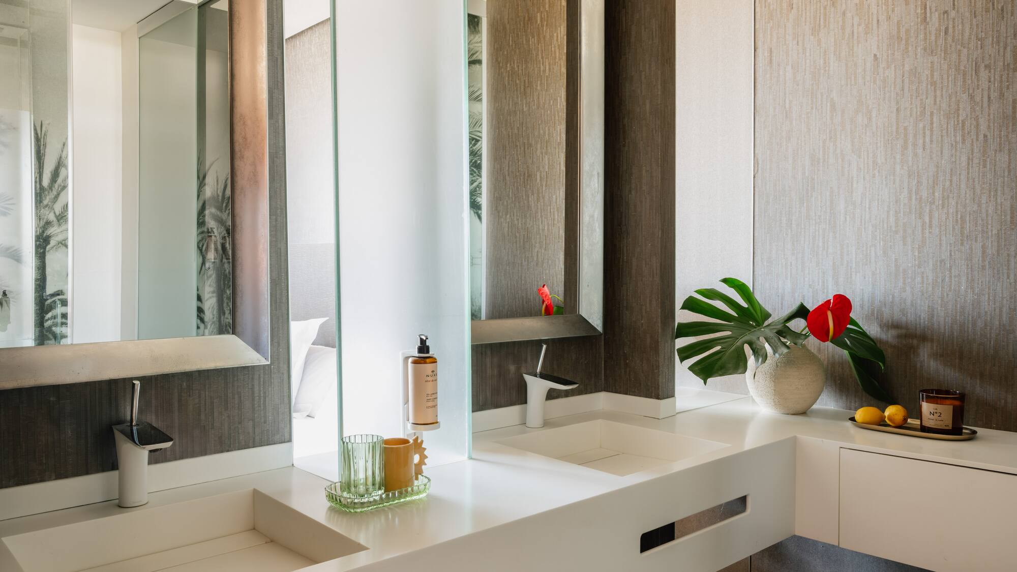 a bathroom with a large mirror and two sinks