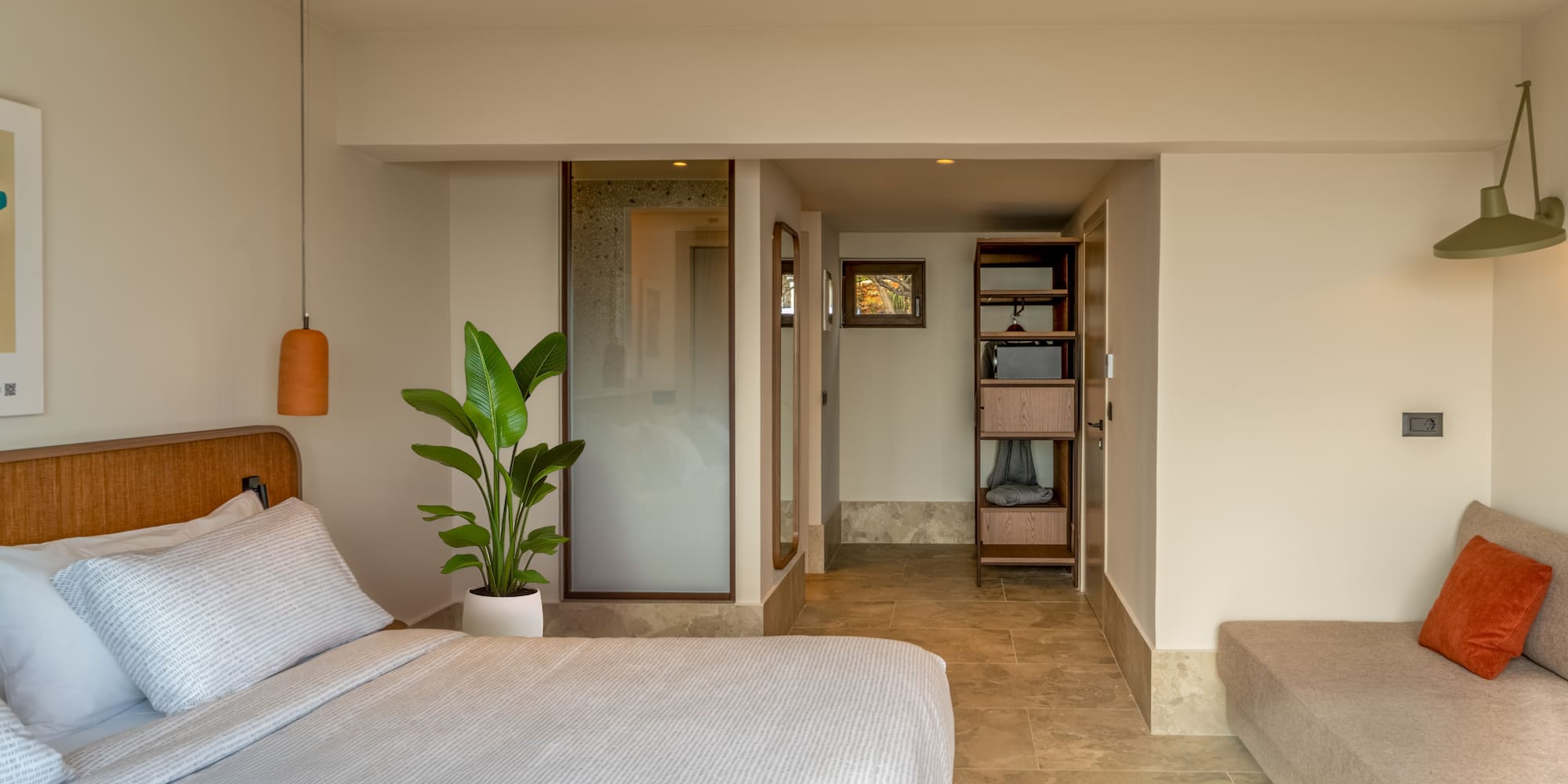 a bedroom with a bed and a plant