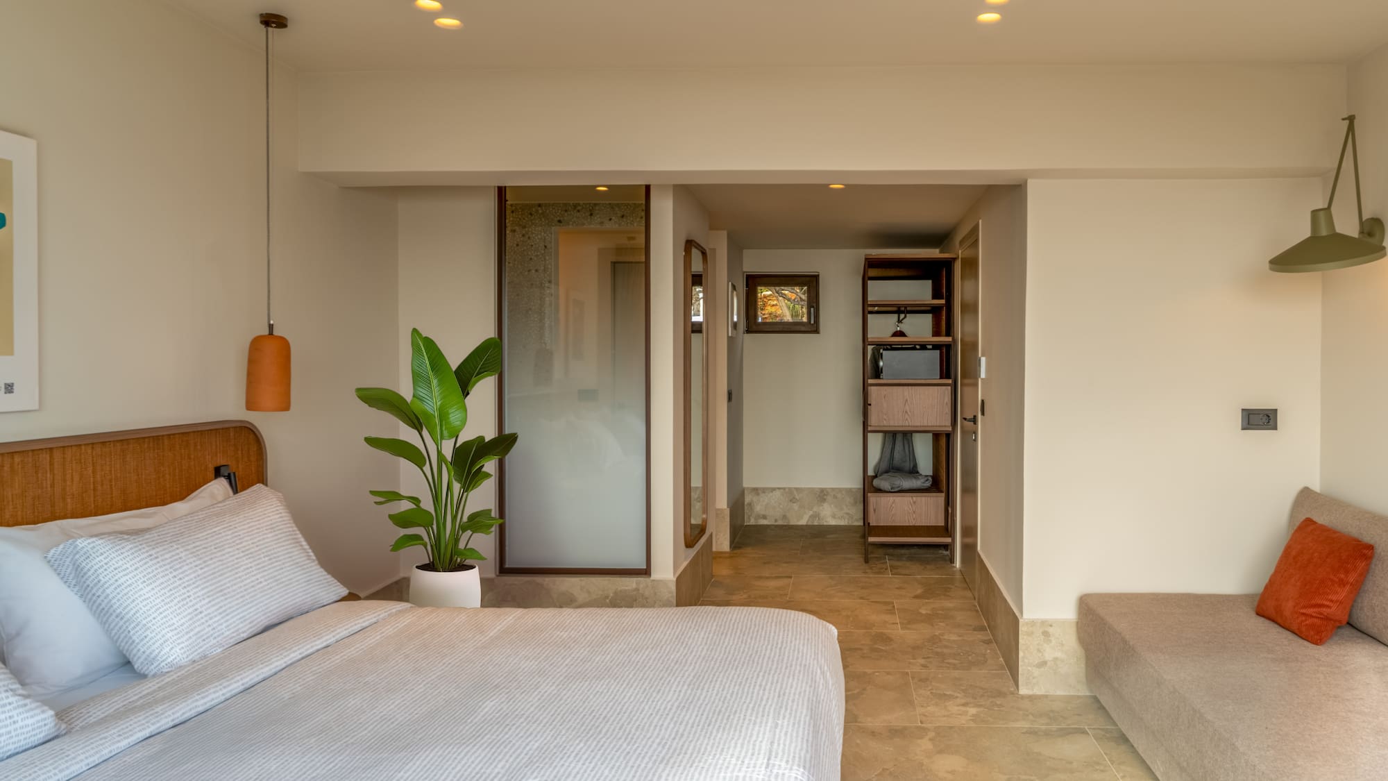 a bedroom with a bed and a plant