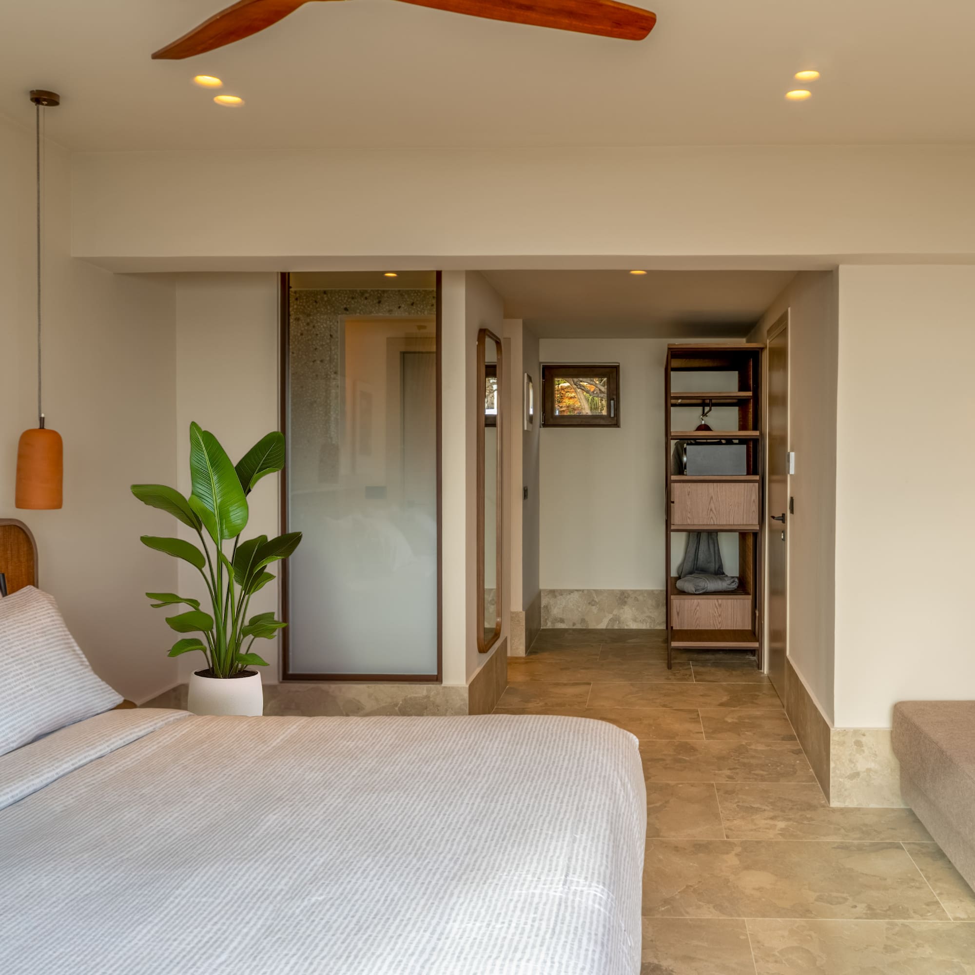 a bedroom with a bed and a plant