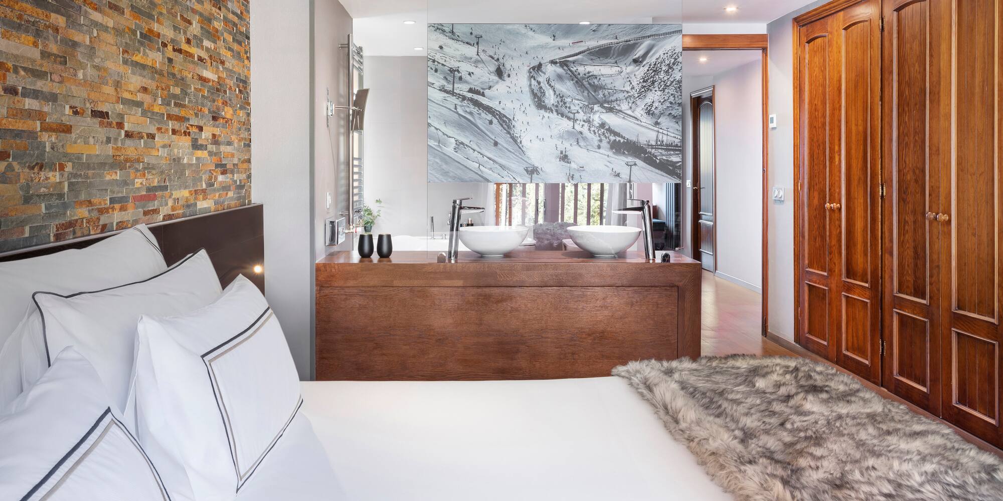 a bed with a fur blanket and a mirror in a room