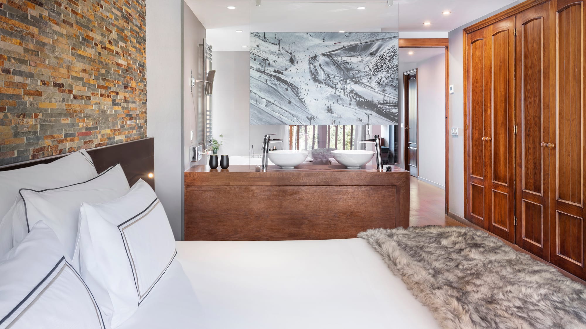 a bed with a fur blanket and a mirror in a room