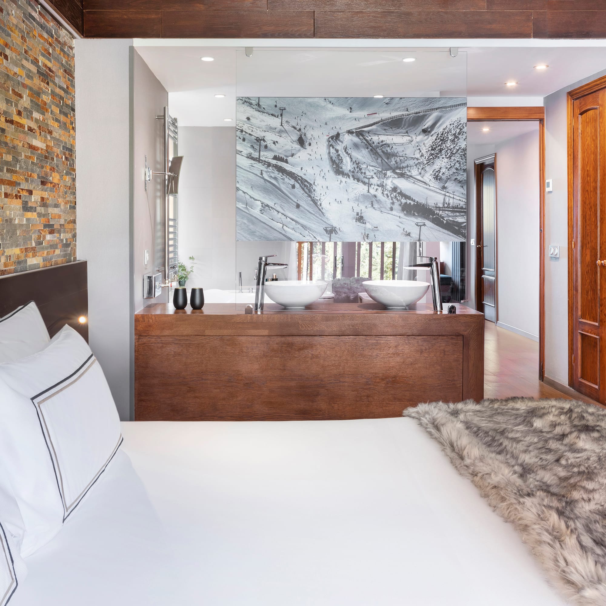 a bed with a fur blanket and a mirror in a room