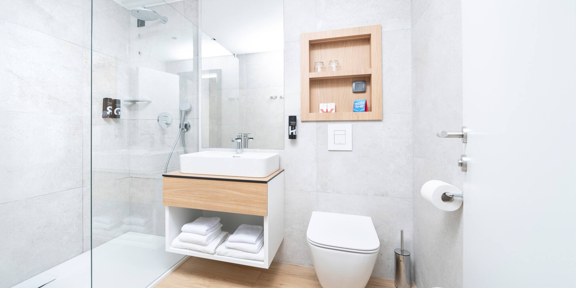 a bathroom with a glass shower and a sink