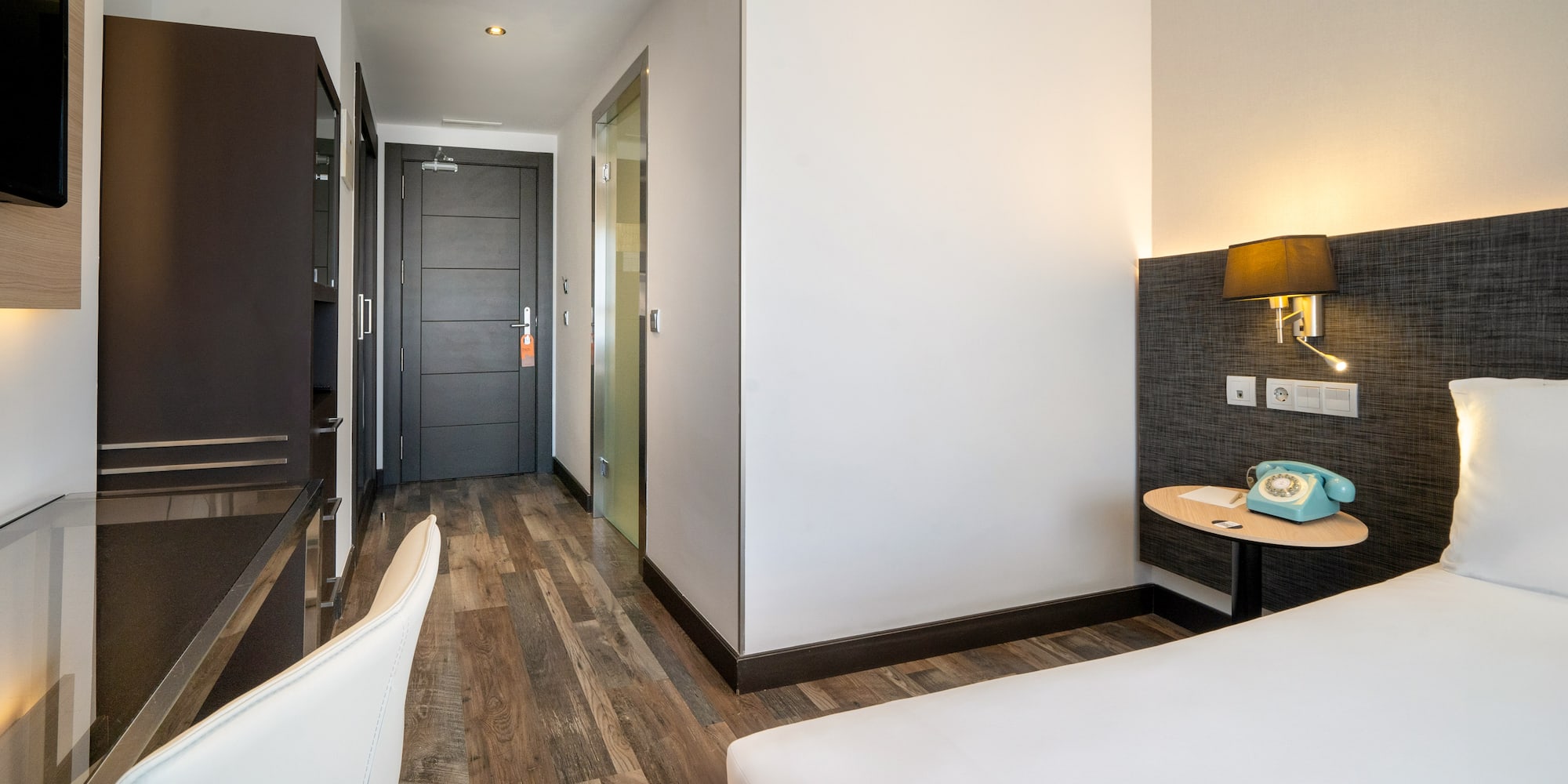 a room with a bed and a desk