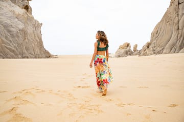 a woman walking on a beach