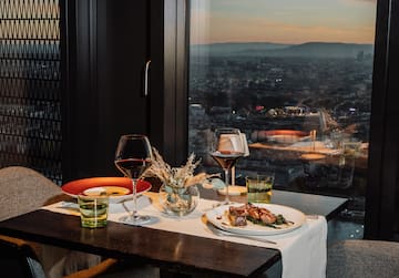 a table with plates of food and wine glasses on it