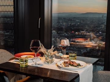 a table with plates of food and wine glasses on it