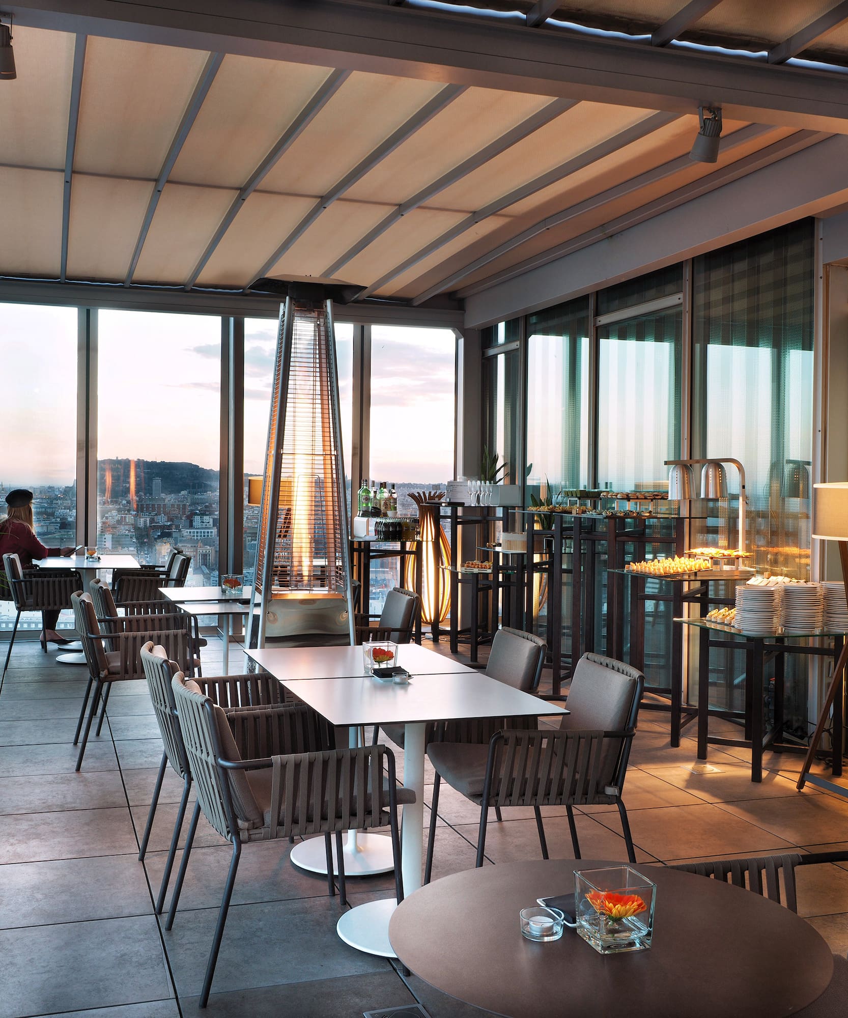 a room with tables and chairs and a fireplace