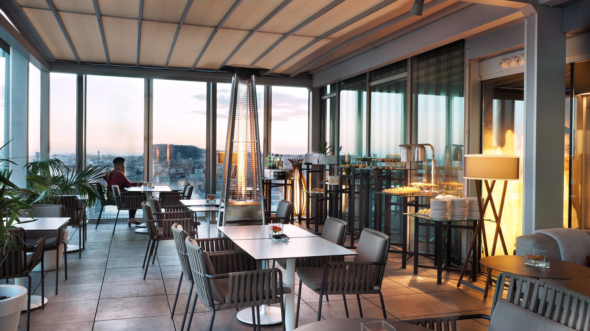 a room with tables and chairs and a fireplace