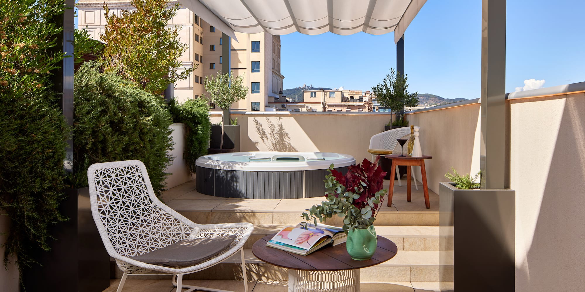 a patio with a hot tub and chairs