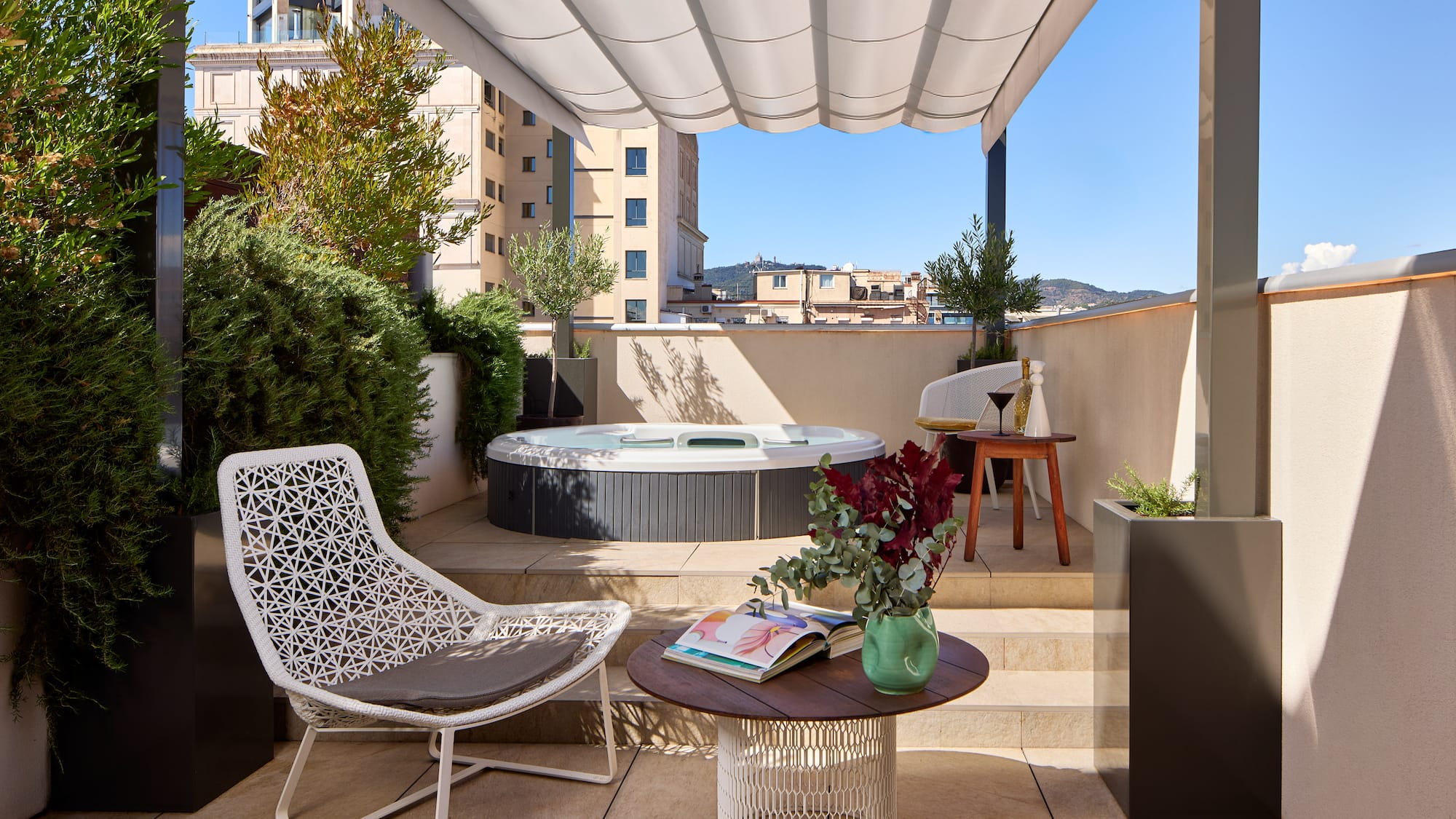 a patio with a hot tub and chairs