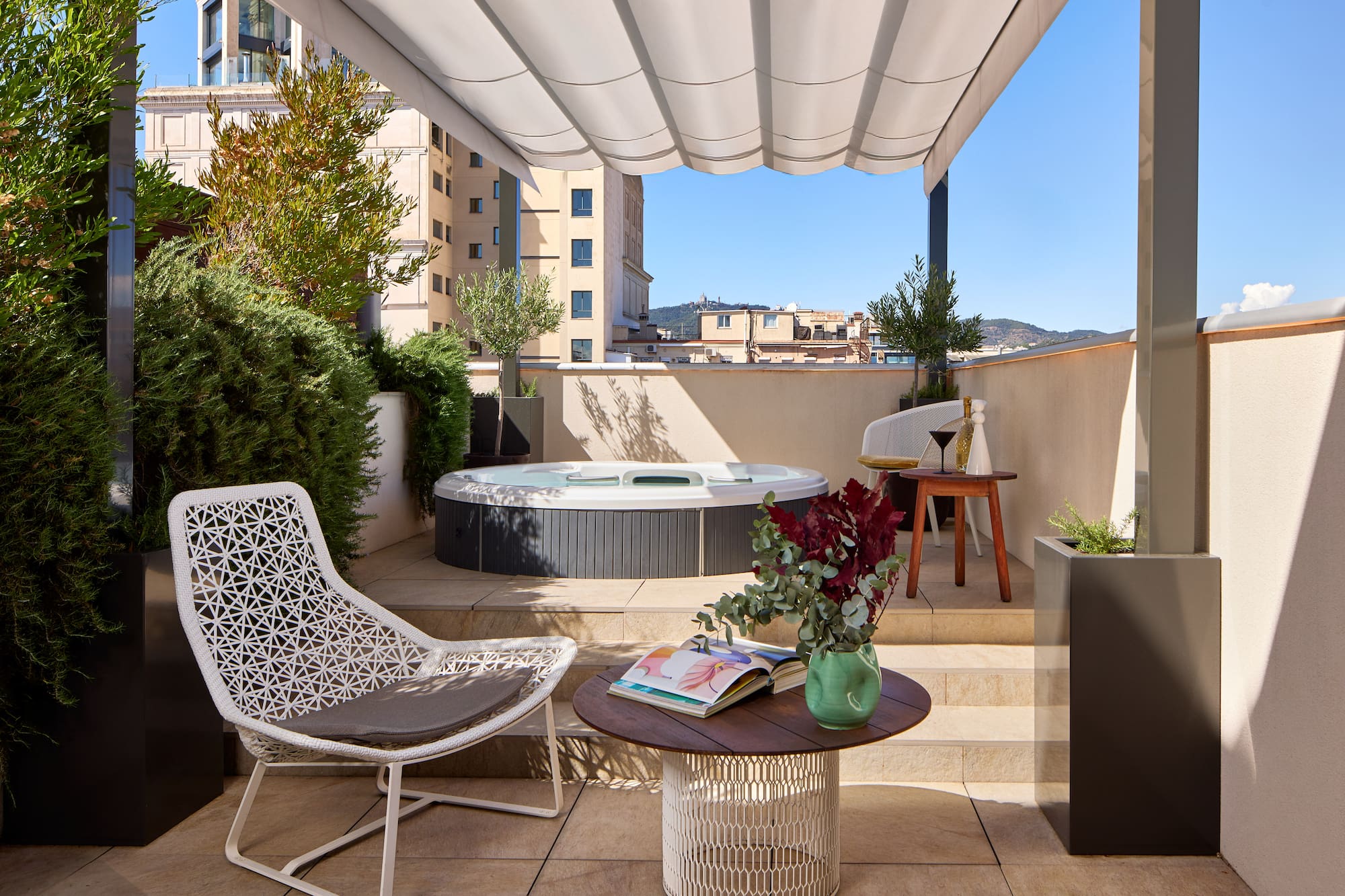 a patio with a hot tub and chairs