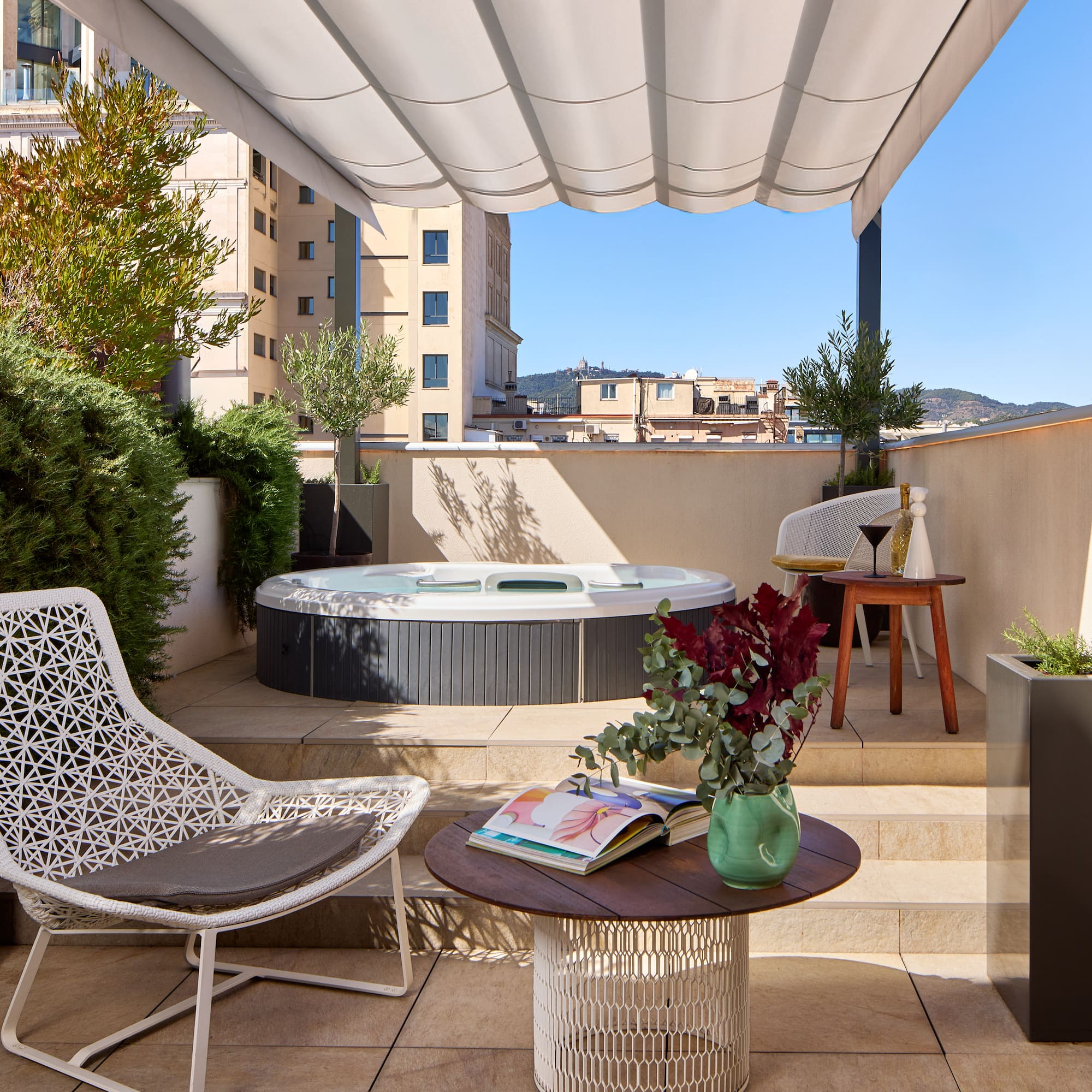 a patio with a hot tub and chairs