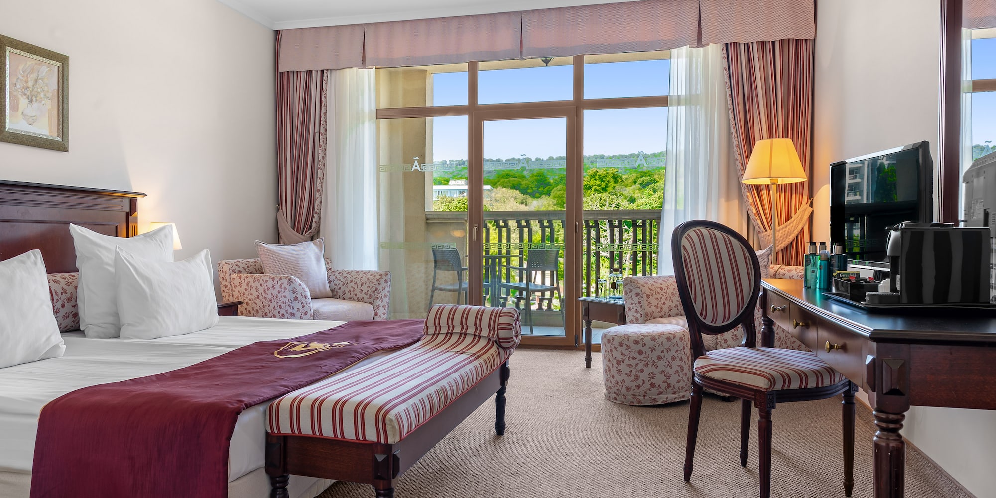 a room with a bed and a table and chairs