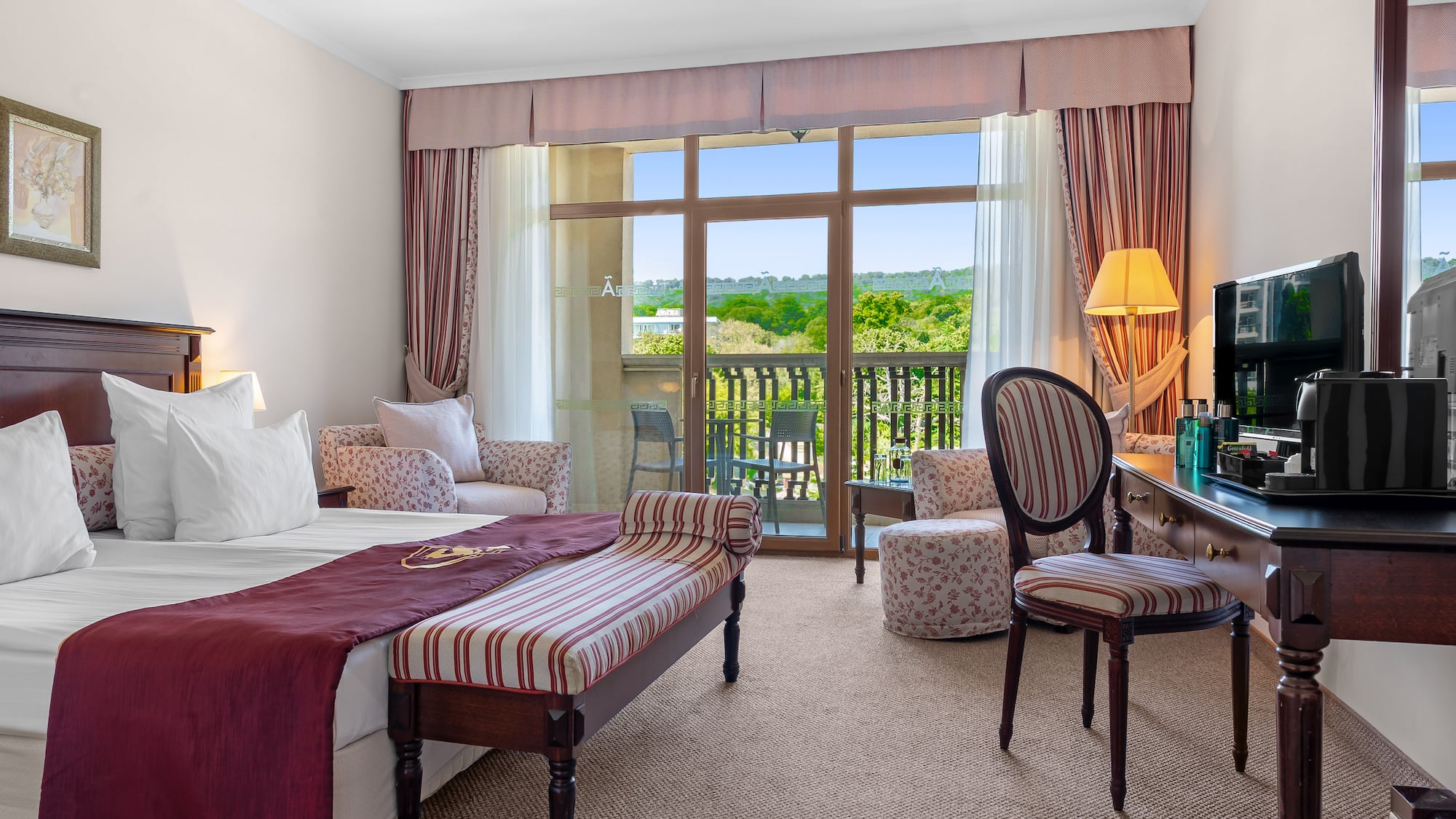 a room with a bed and a table and chairs