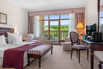 a room with a bed and a table and chairs