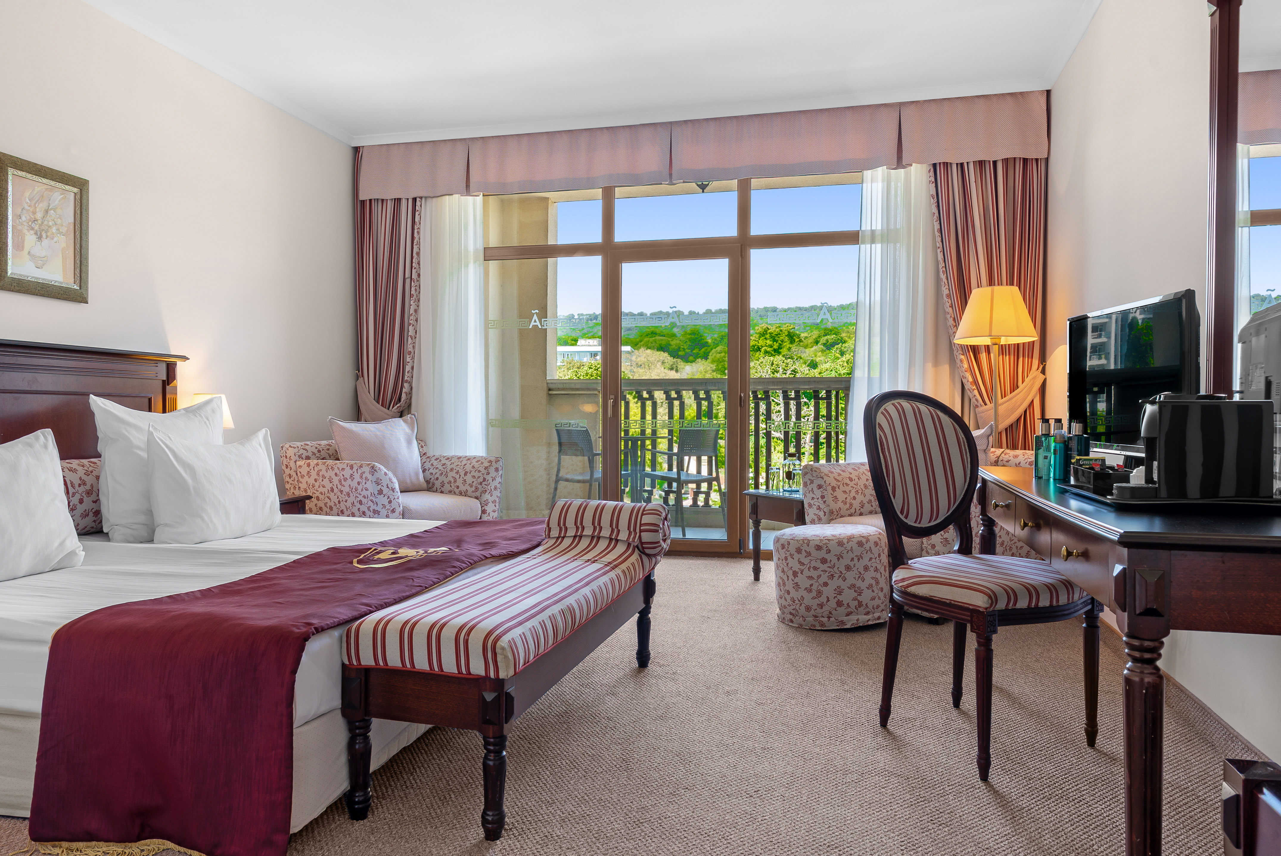 a room with a bed and a table and chairs