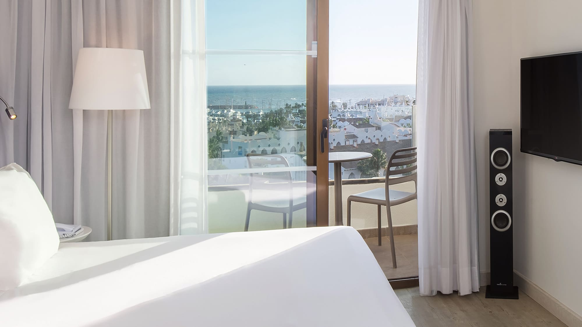 a bedroom with a large window and a television