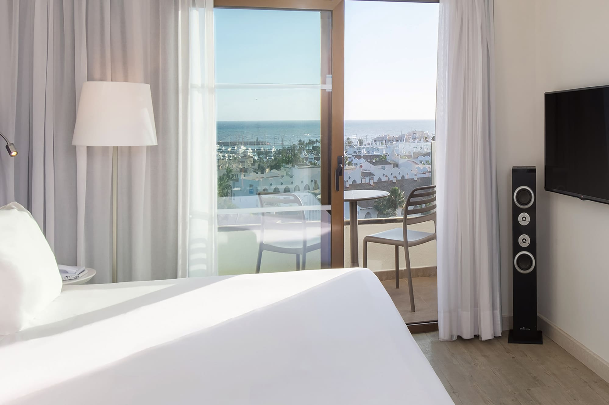 a bedroom with a large window and a television