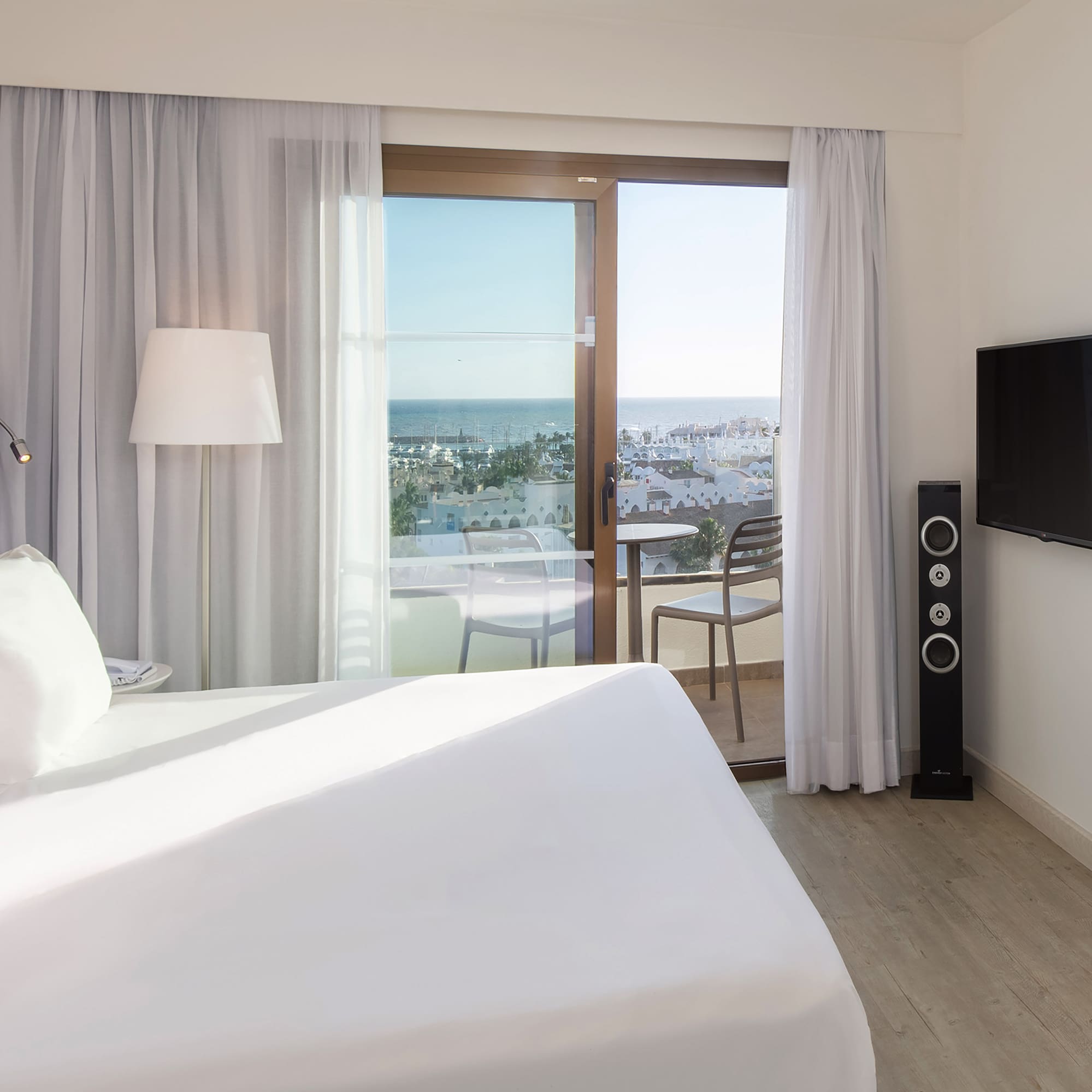 a bedroom with a large window and a television