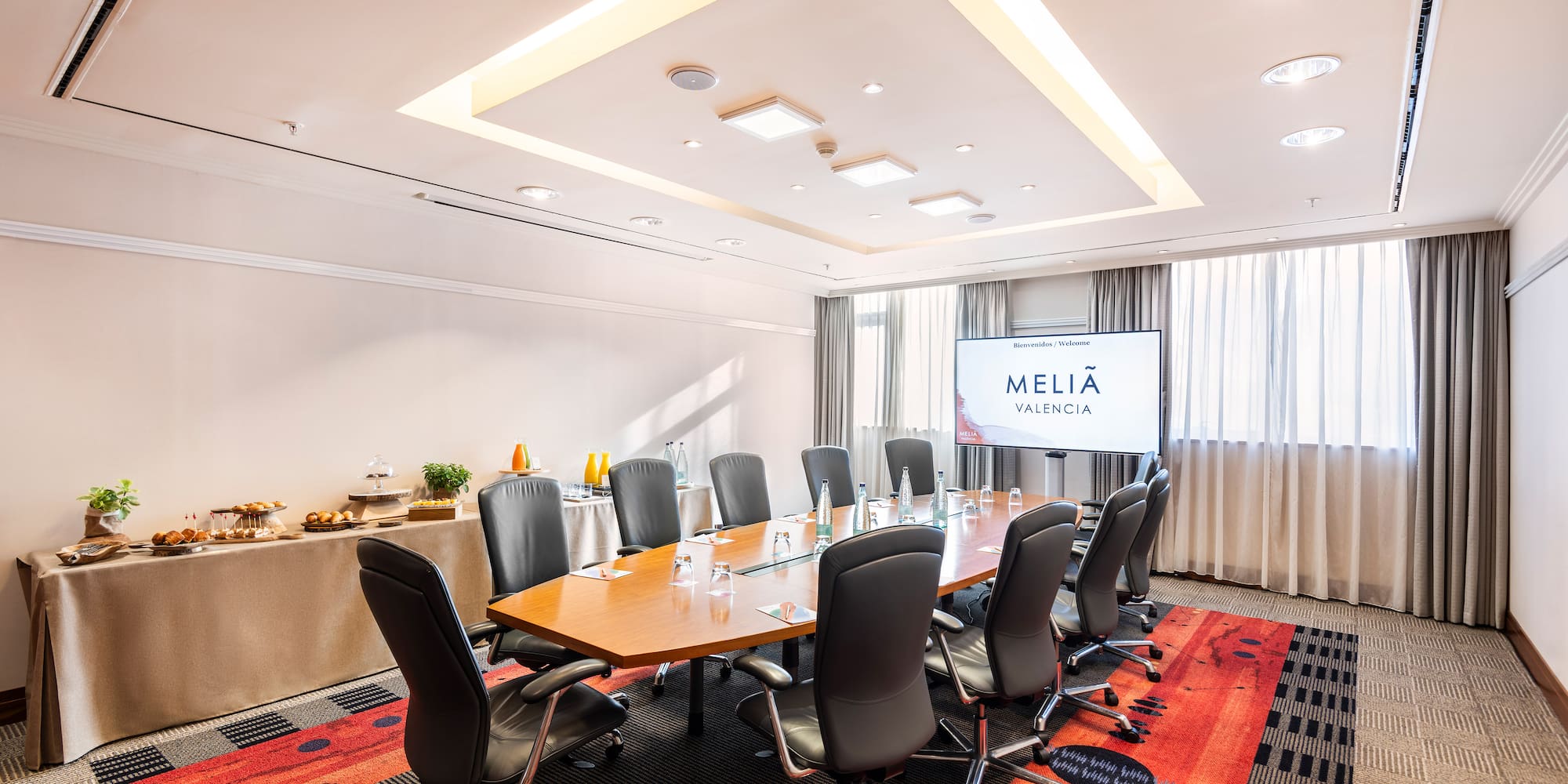 a conference room with a table and chairs