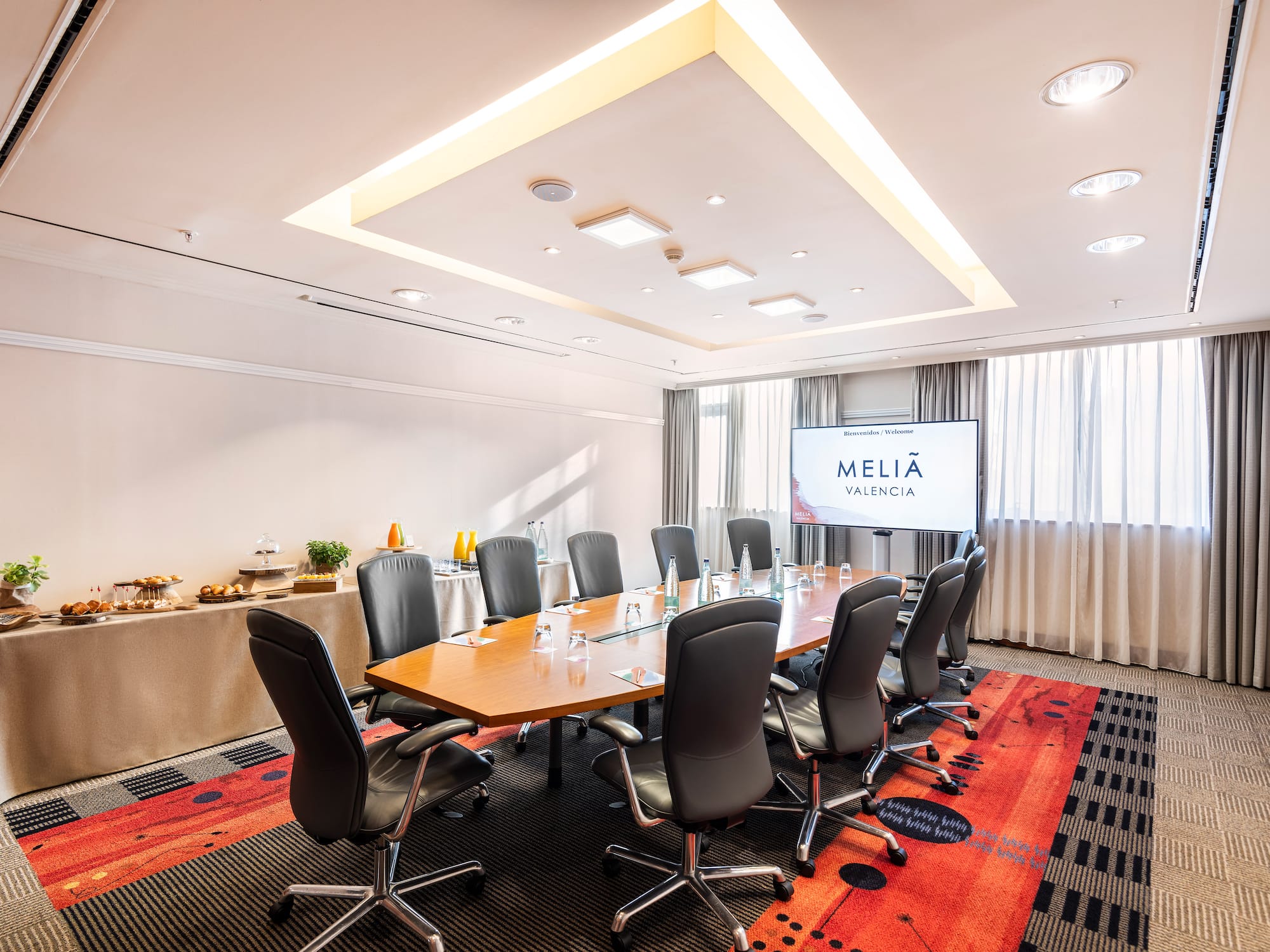 a conference room with a table and chairs
