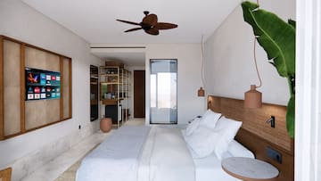 a bedroom with a bed and a ceiling fan