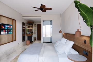 a bedroom with a bed and a ceiling fan