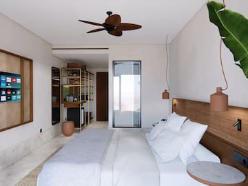 a bedroom with a bed and a ceiling fan