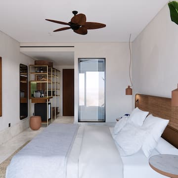 a bedroom with a bed and a ceiling fan