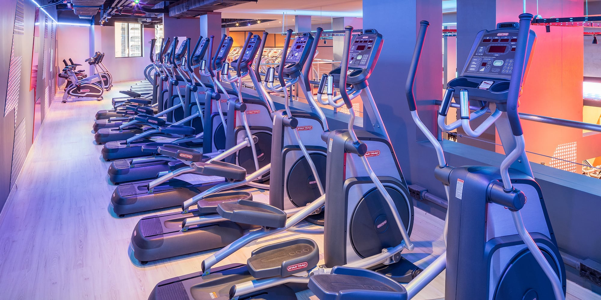 a group of exercise machines in a gym