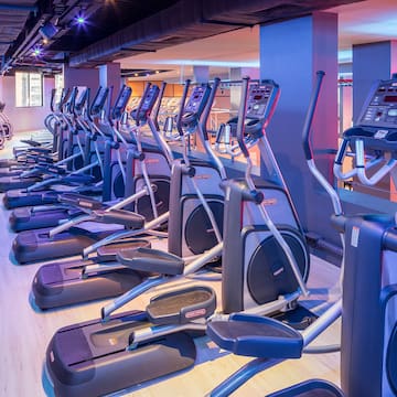 a group of exercise machines in a gym