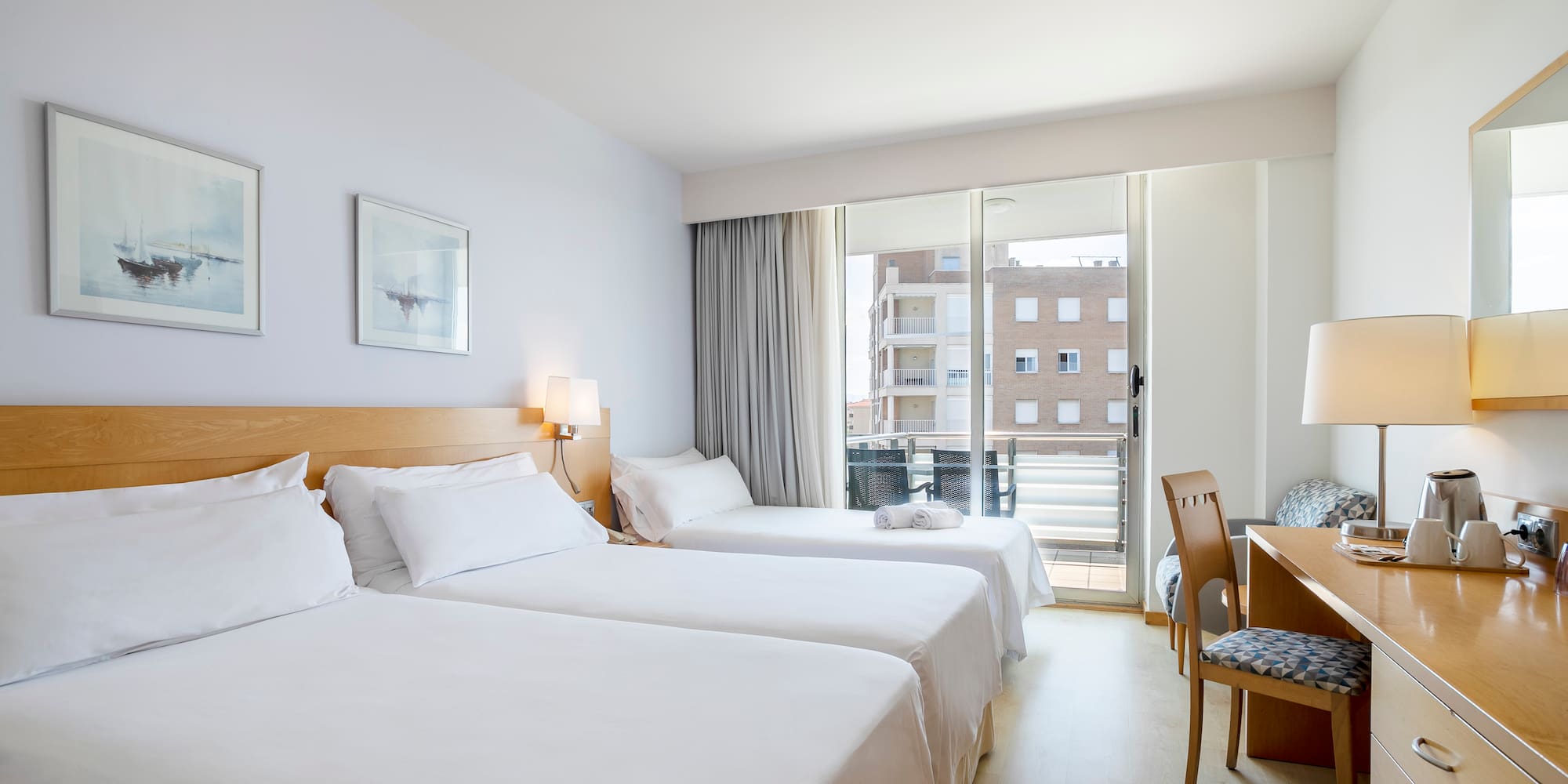 a room with two beds and a desk