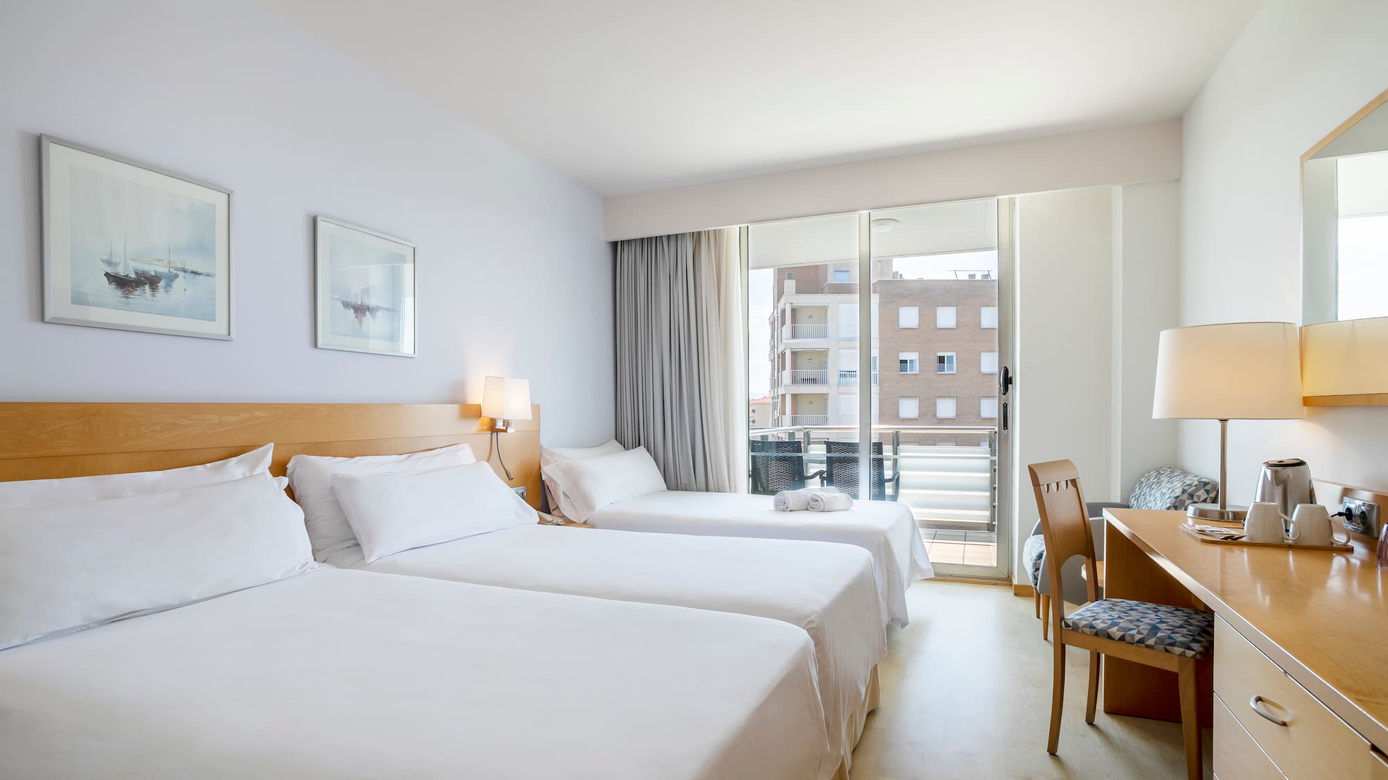 a room with two beds and a desk