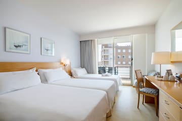 a room with two beds and a desk