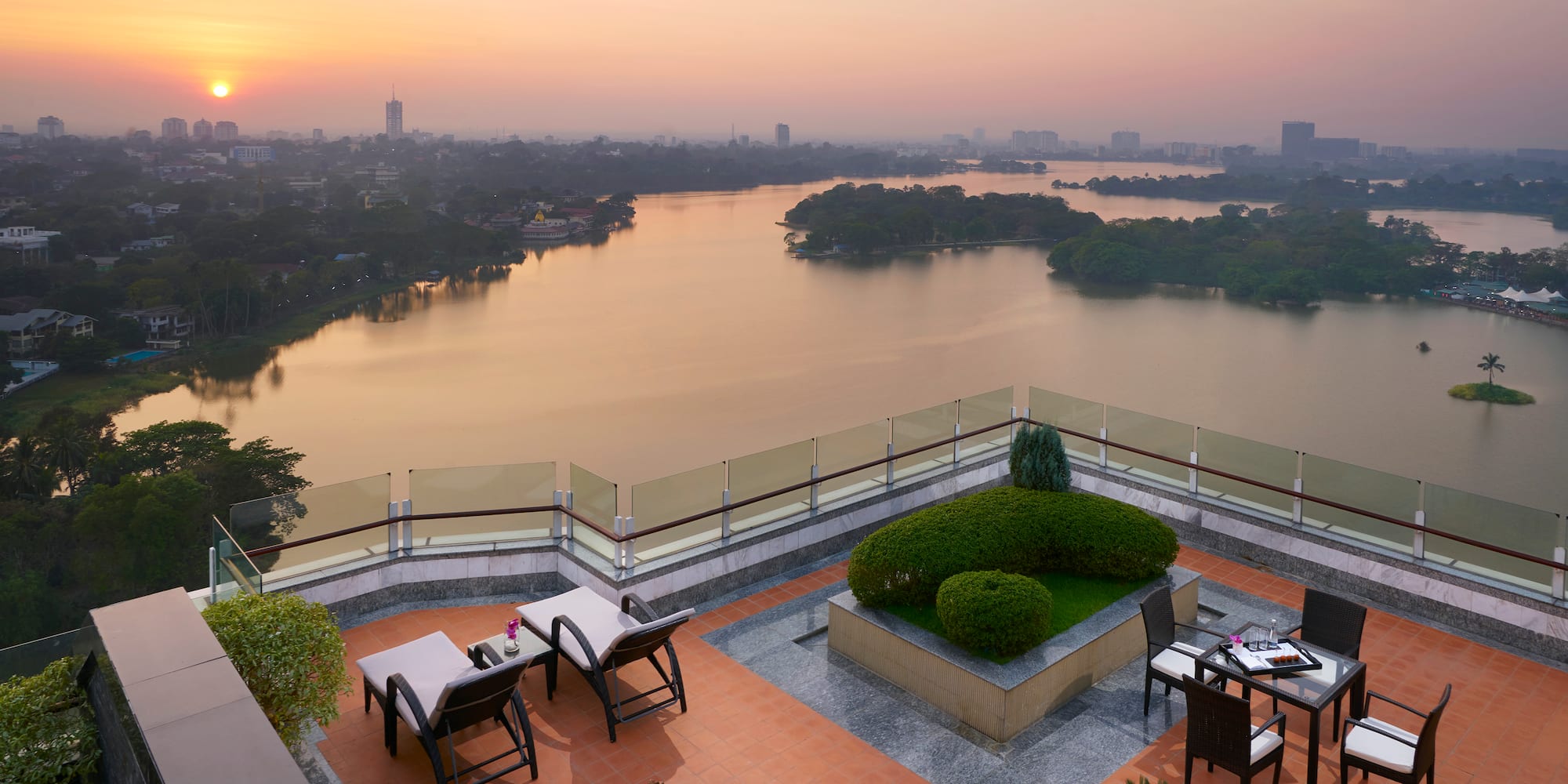 a rooftop patio overlooking a body of water