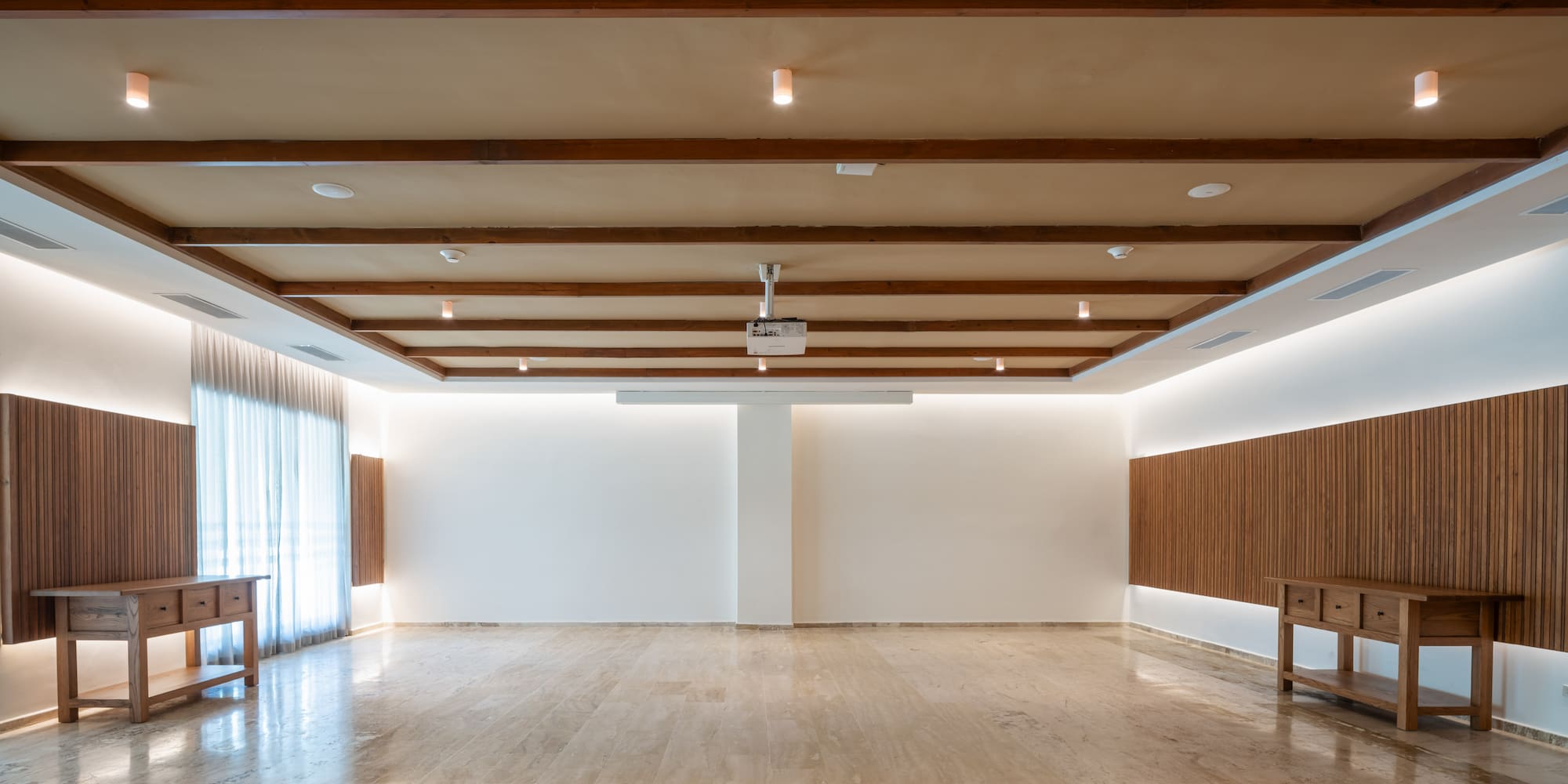 a room with a wood ceiling and a table
