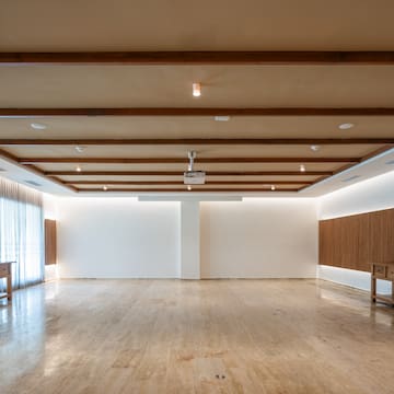 a room with a wood ceiling and a table
