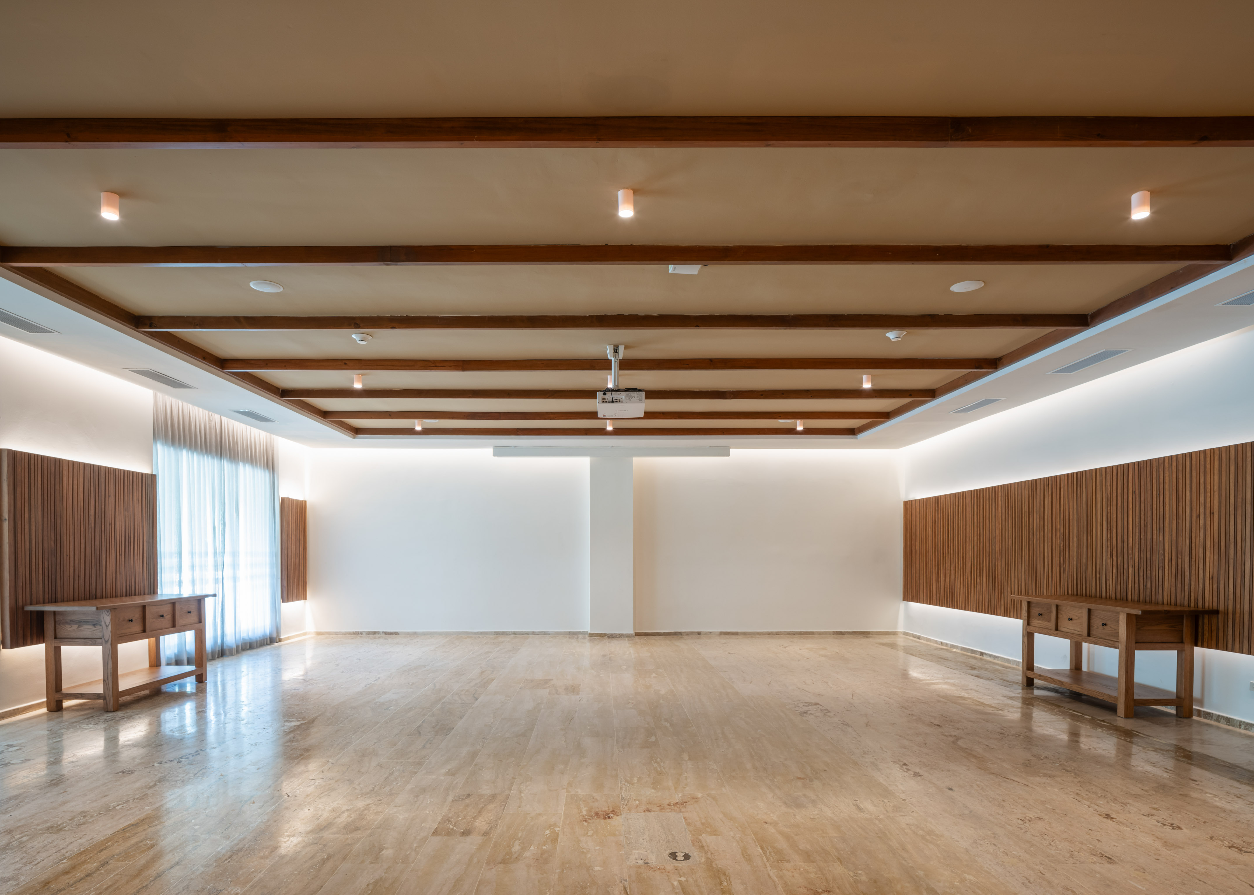 a room with a wood ceiling and a table