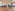 Modern conference room, empty grey chairs, wooden floor, and ambient lighting.