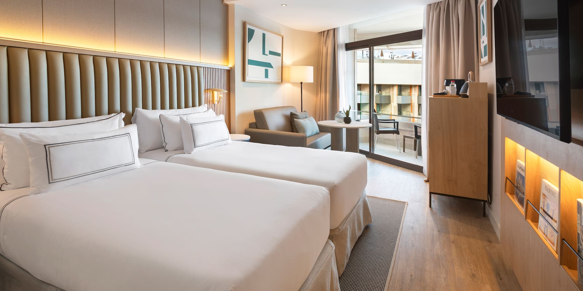 a room with two beds and a table