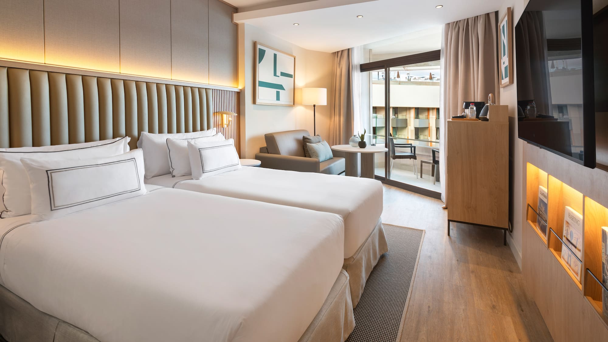 a room with two beds and a table