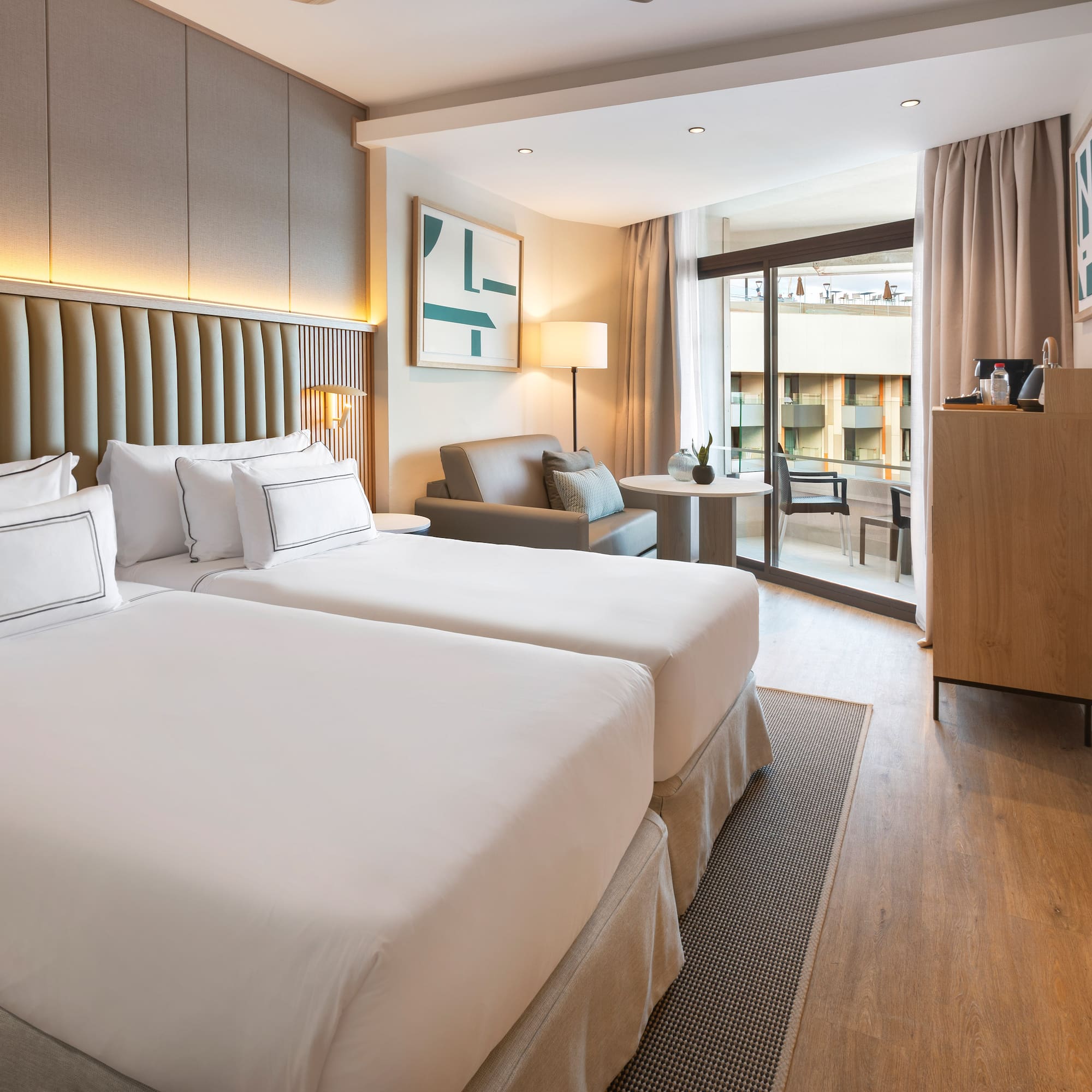 a room with two beds and a table