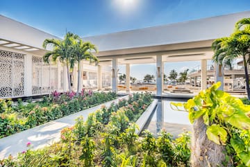 a building with a pool and plants