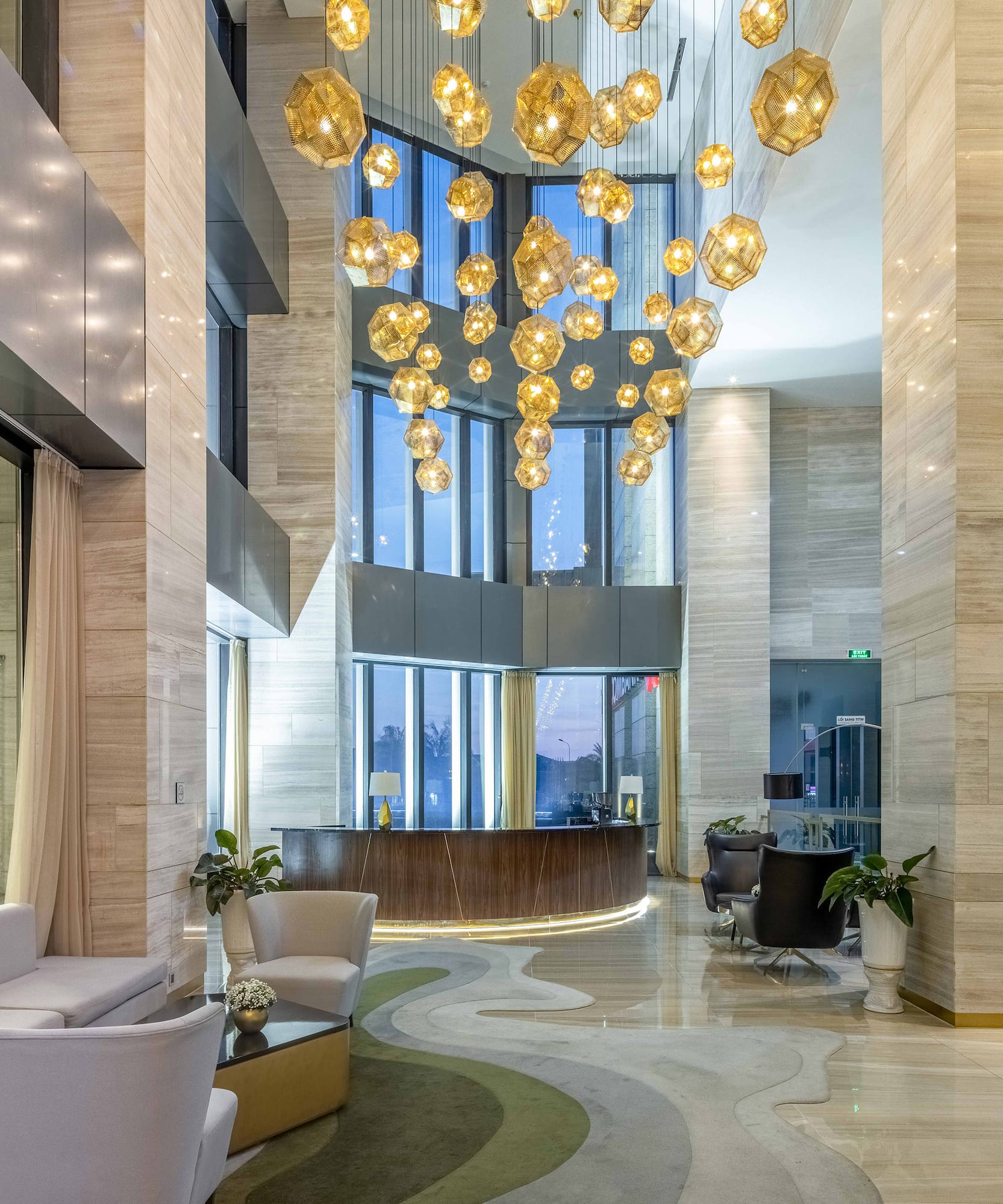 a lobby with a large chandelier and a reception desk