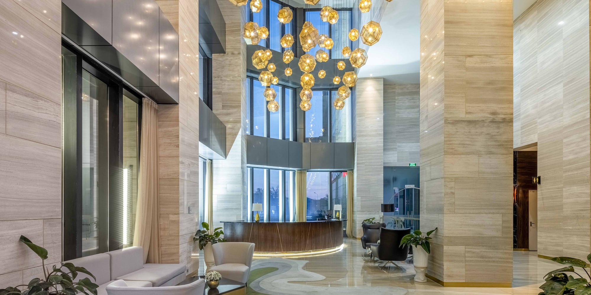 a lobby with a large chandelier and a reception desk