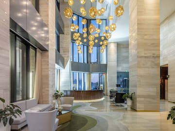a lobby with a large chandelier and a reception desk
