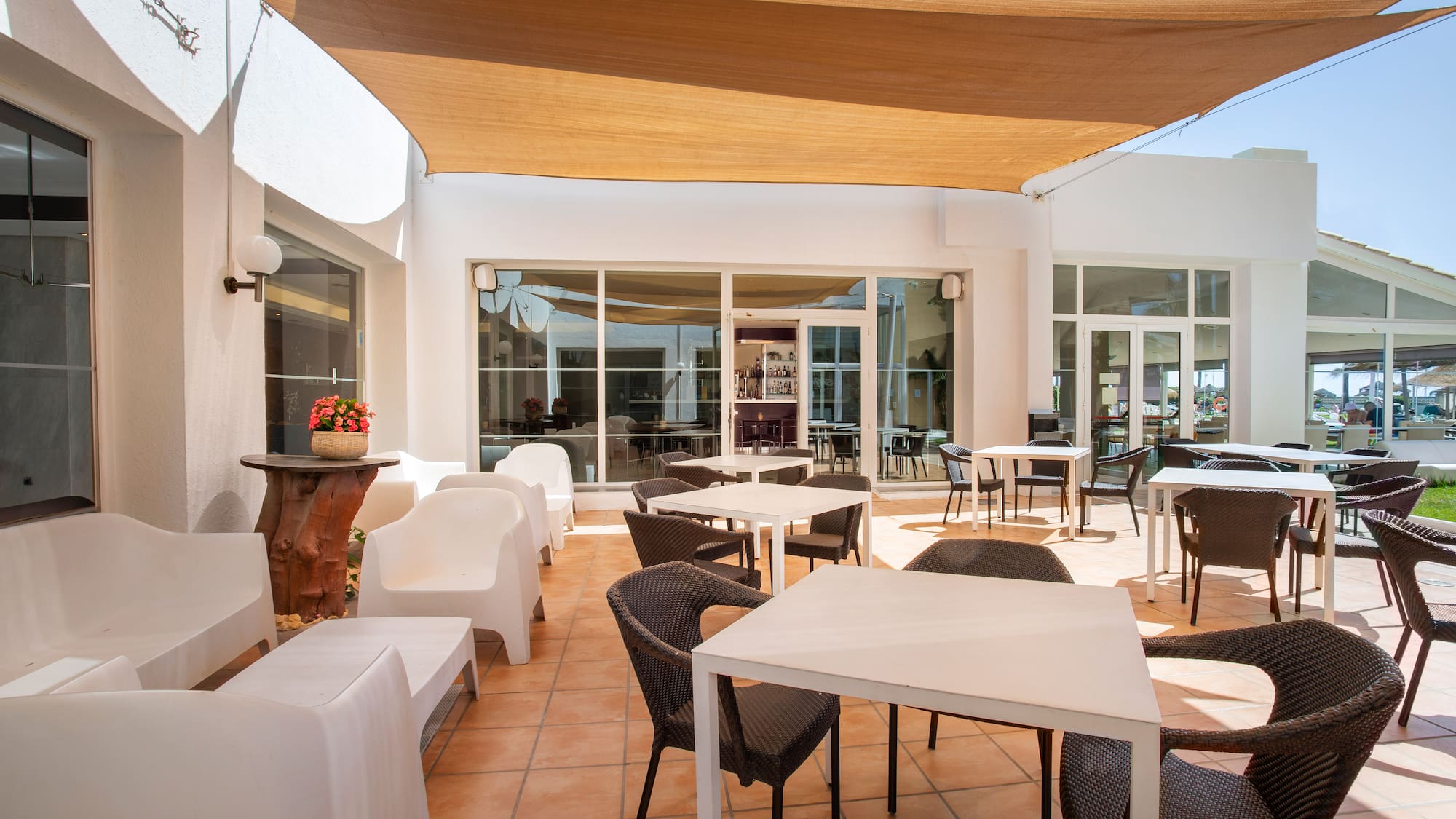 a patio with chairs and tables