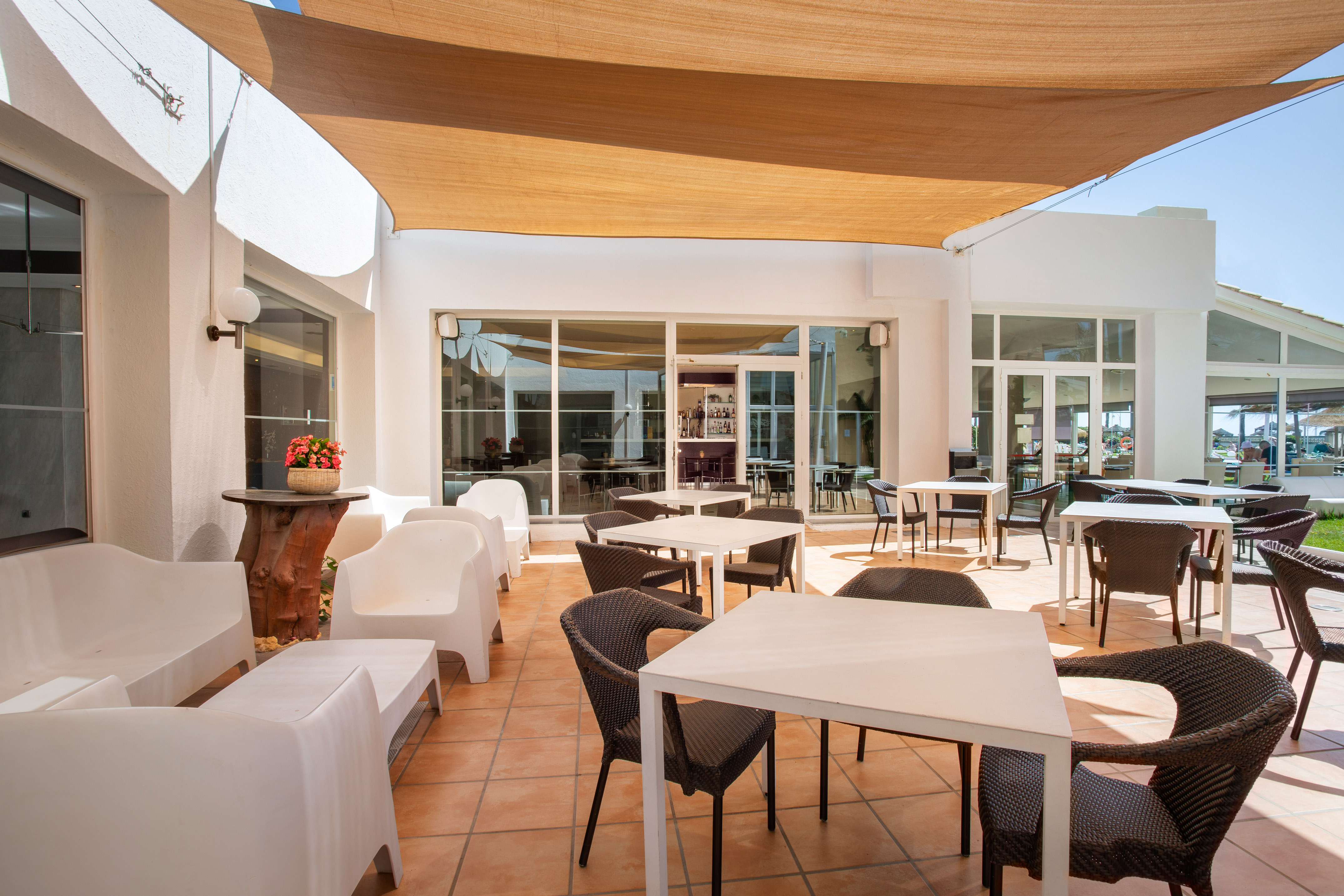 a patio with chairs and tables